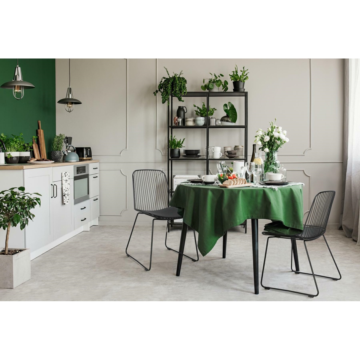 Elegant grey and green kitchen with breakfast on round dining room table